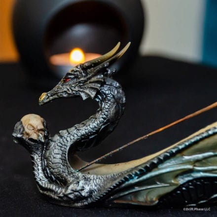 Close-up detail of the dragon holding skull incense burner.
