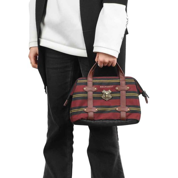 Attribute: Model holding Hogwarts Lunch Tote with metal emblem