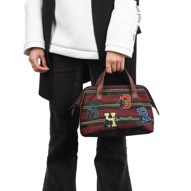Model holding Hogwarts Lunch Tote with house icons