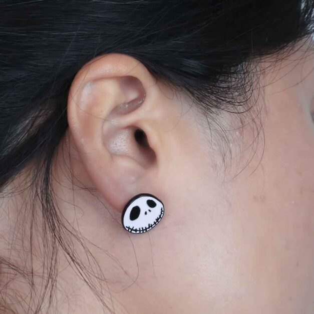 Model Sporting Jack Smiling Earrings from The Nightmare Before Christmas Collection